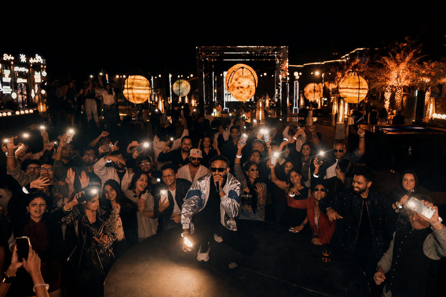 Vishaal surrounded by guests during a concert-night celebration