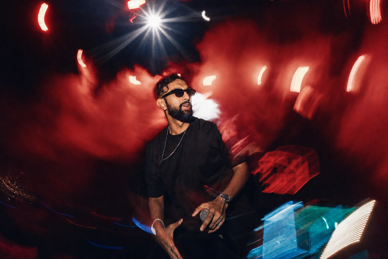 Vishaal performing amid dramatic red concert lighting